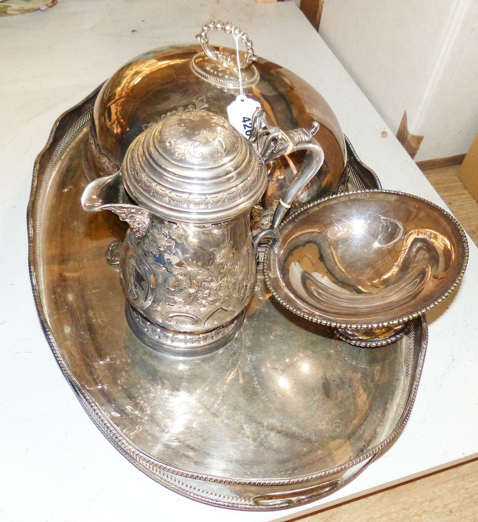 A Victorian embossed silver plated jug, oval tray, meat cover and spoon